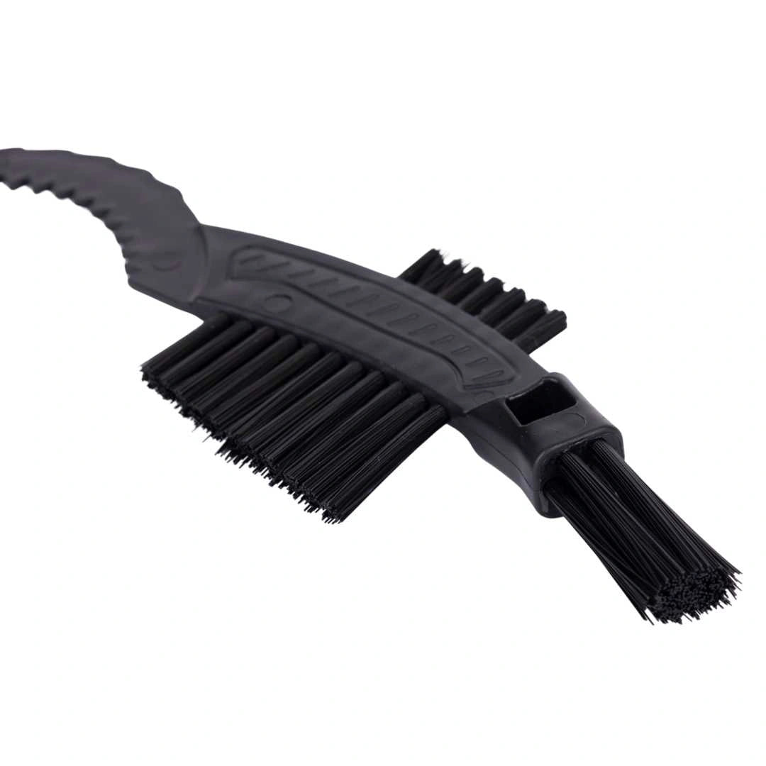 A close-up of the Claw Brush, a black plastic cleaning tool with stiff bristles, curved handle, and dual heads—perfect for fietsonderhoud and ideal as a cassette borstel or kettingreiniger.