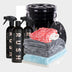 The Bonus Bucket Kit includes three black spray bottles, a black bucket with grit guard, a red-and-white wash mitt, stacked microfiber towels (gray, blue, white), and RUSH Gold Wash for exceptional car cleaning results.