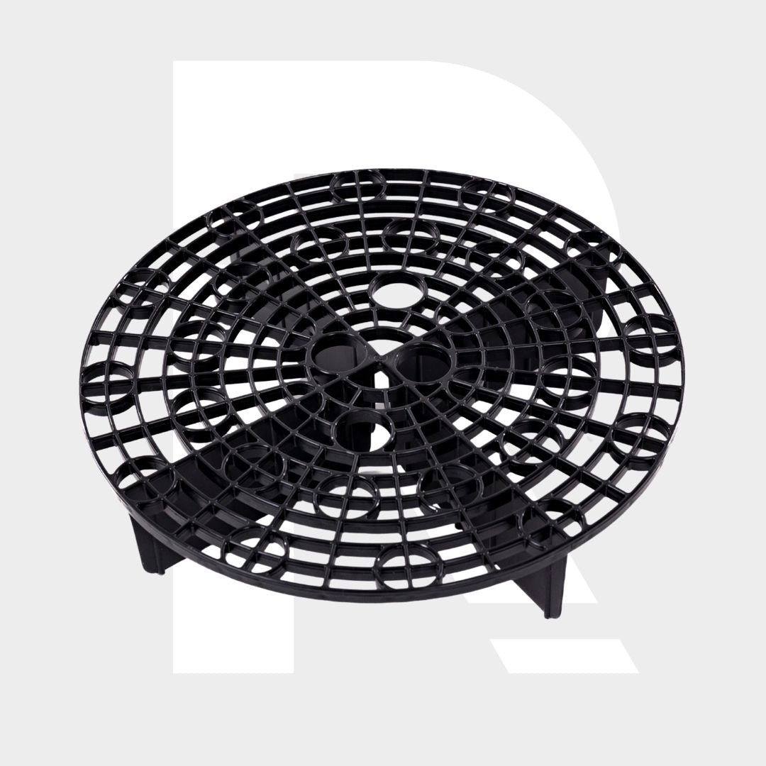 A black, round plastic Grit Guard with a raised base and intersecting lines is shown on a light gray background.