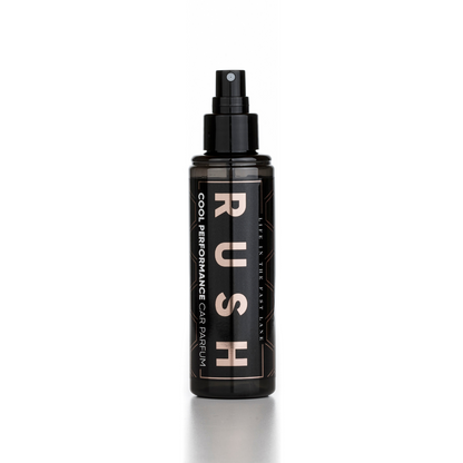 A black spray bottle labeled Cool Performance - 125 ml stands upright on a reflective white surface, showcasing its stylish design and long-lasting fragrance, set against a plain white background.